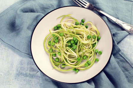 Zucchini noodles with green peas. Top viewの写真素材