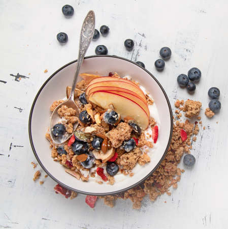 Bowl of granola with yogurt and fresh fruits for healthy breakfast. の写真素材