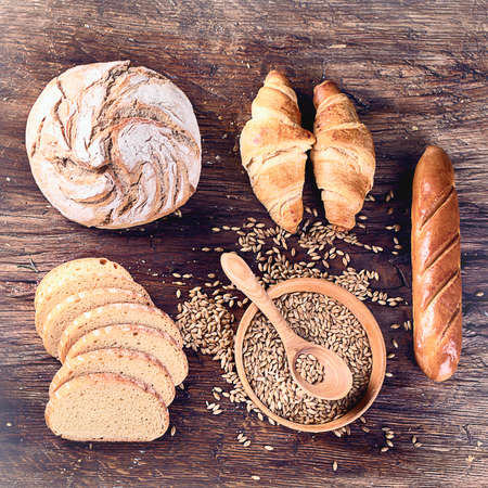 Fresh baked bread on rustic wooden backgroundの写真素材