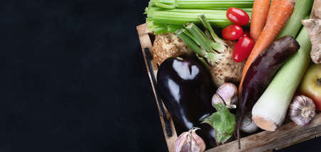 Local fresh raw vegetables in wooden box with copy space. Panorama