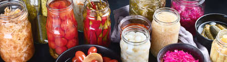Fermented preserved food. Marinated pickles vegetables in glass jars. Panoramaの写真素材