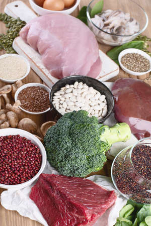 Iron rich foods as liver, beef, eggs,  lentil, bean,  broccoli, mushrooms, guinoa and seafood on wooden table. Healthy eating conceptの写真素材