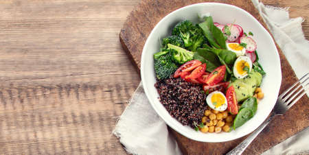 Healhty vegan lunch bowl. Salad with quinoa, broccoli, radish and chickpea. Panorama, banner with copy spaceの写真素材