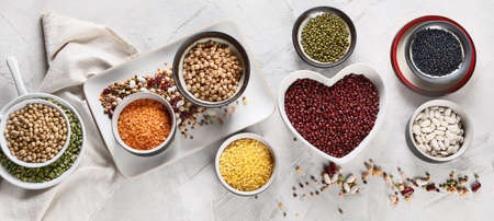 Assortment of colorful legumes. Healthy eating concept. Vegan proteins.  Top view. Panorama, banner