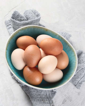 Fresh farm chicken eggs on grey background. Top view