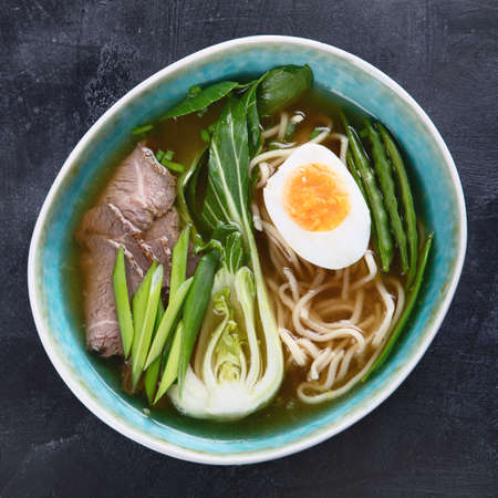 Asian beef noodle soup on dark background. Top viewの写真素材