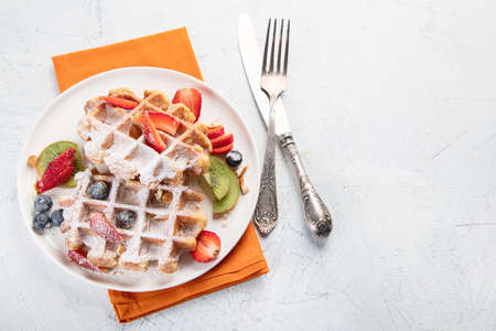 Traditional belgian waffles with fresh fruit. top view with copy spaceの写真素材
