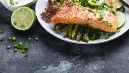 Grilled salmon with vegetables on blackの写真素材