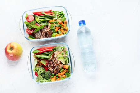 Healthy lunch box with chicken, quinoa and vegetables. Balanced diet eating conceptÑŽ Top view...