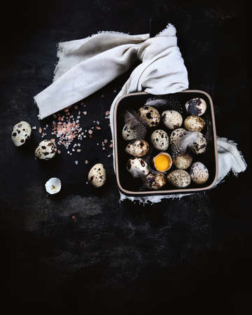 Quail eggs on black background. Healthy food  high in vitamins and minerals. Top view, flat lay.  Image with copy spaceの写真素材