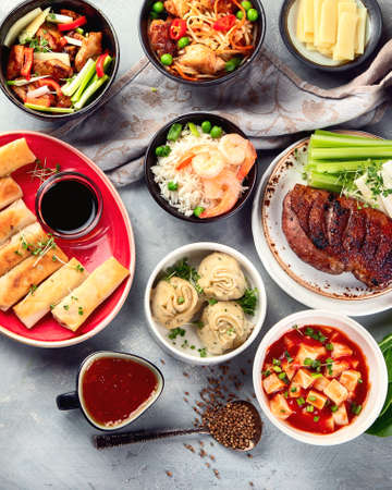 Assorted Chinese dishes on greyの写真素材