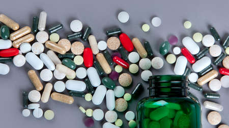 Heap of pills on grey background. Top view, flat layの写真素材