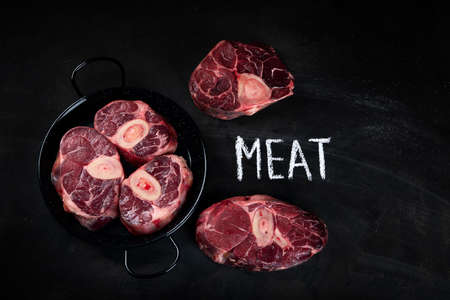 Ossobuco Veal shank on  black background. Top view with copy spaceの写真素材