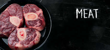 Ossobuco Veal shank on  black background. Top view with copy spaceの写真素材