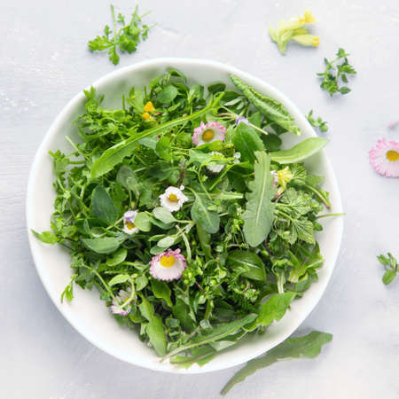 Mixed salad leaves with edible flowers. Healthy food concept. Top view with copy spaceの写真素材