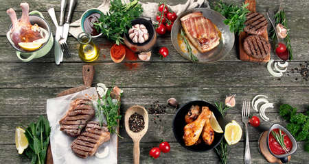 Different types of Grilled meat  on rustic wooden table. Top viewの写真素材