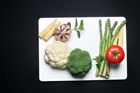 Fresh vegetables  on white cutting borad. Top view, flat layの写真素材