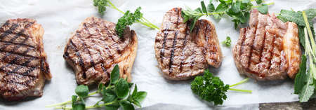 Grilled beef steaks  on wooden board. Top view with copy spaceの写真素材