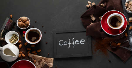 Red coffee cup and beans on dark table. Top view with copy spaceの写真素材