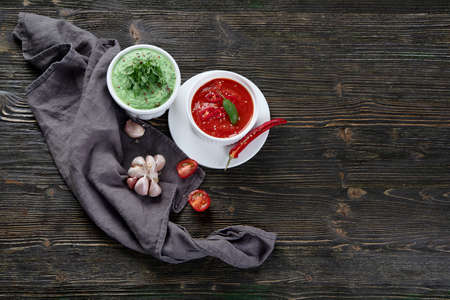 Sauces on dark wooden background. Top view with copy space