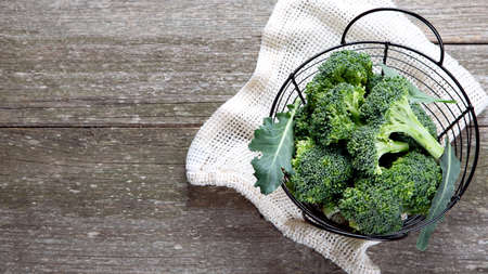 Raw cauliflower and broccoli on wooden rustic table. Delicious fresh vegetables. The concept of healthy food. Top view, flat lay with copy space.の写真素材