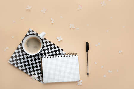 Morning cup of coffee, empty notebook, snacks and hydrangea flowers. Top view, flat lay.