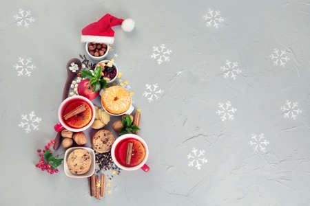 Christmas Tree made of holiday food on concrete background. Top view, flat lay with copy space....