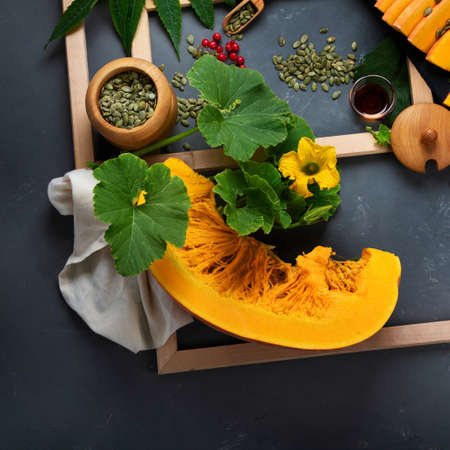Festive autumn decor from raw pumpkins, berries and leaves. on dark backgroundの写真素材