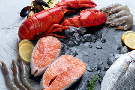 Assortment of fresh raw fish and seafood. Healthy and balanced diet or cooking concept.の写真素材