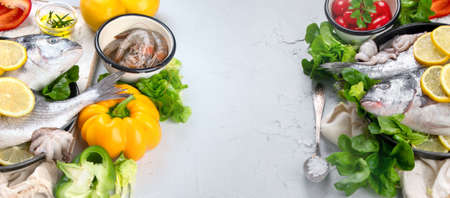 Raw dorado fish with vegetables. Panorama, banner with copy spaceの写真素材