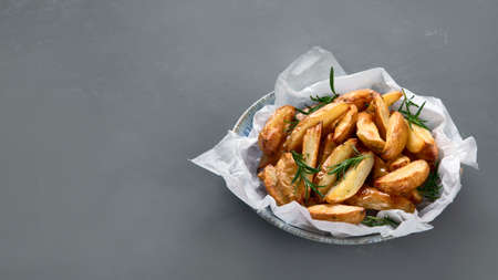Baked country style potato wedges with herbs and sauce. Copy spaceの写真素材