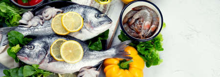 Raw dorado fish with vegetables. Panorama, bannerの写真素材