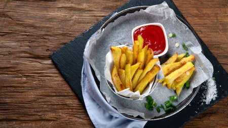 Homemade baked potato fries. Top view, copy space