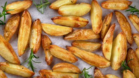 Baked country style potato wedges with herbs and sauce. Top view, copy space