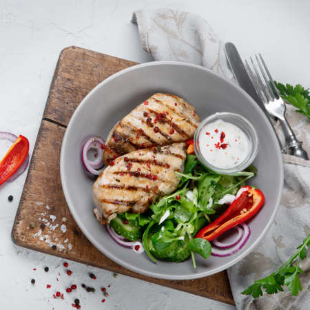 Grilled chicken fillet and fresh vegetable salad. Healthy food. Keto diet. Top viewの写真素材