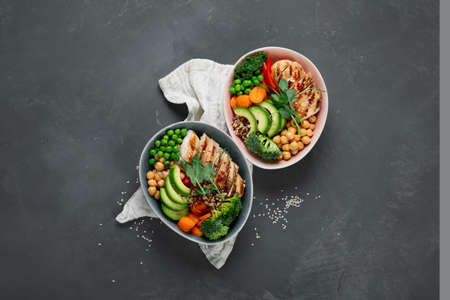 Healthy chicken Buddha bowl with vegetables, chickpea and quinoa. Grilled chicken salad. Clean and balanced healthy food concept. Top view, copy spaceの写真素材