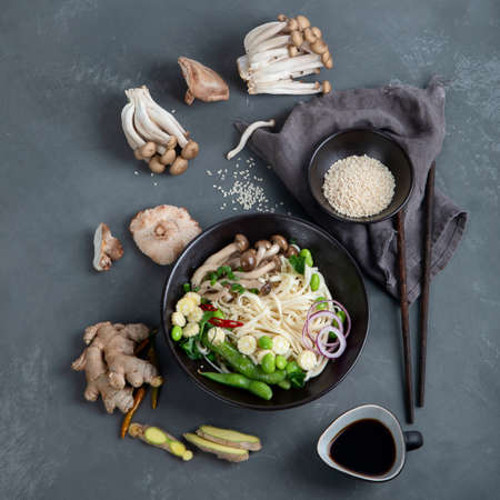 Udon noodles with mushroom and vegetables. Asian style healthy food. Top view, copy space
