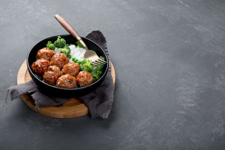 Homemade meatballs with fried rice with vegetables. Balanced and healthy food. Copy spaceの写真素材