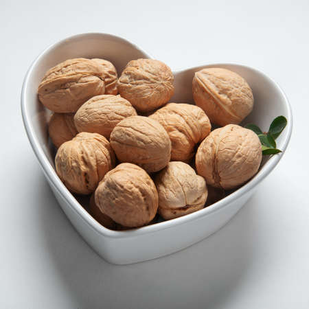 Wallnuts in dark bowl. Healthy vegetarian protein nutritious food. Natural nuts snacks.