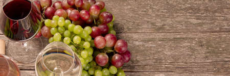 Variety of wine and snack set. Different types of grapes. Fresh ingredients on wooden background....
