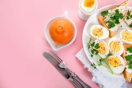 Breakfast with eggs and sandwiches. Ingredients for cooking. Healthy eating concept. Top view, copy spaceの写真素材