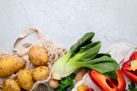 Selection of fresh raw vegetables, fruits and beans on light gray background. Organic food concept. Top view, copy spaceの写真素材
