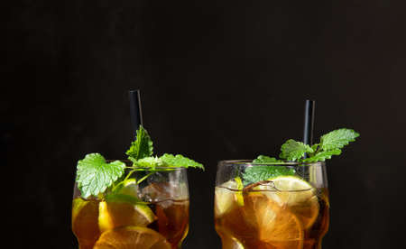 Fresh made longdrink Cuba libre cocktail on dark background. Front viewの写真素材