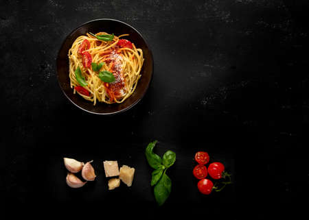 Assortment of Italian pasta with traditional sauces for dinner on dark background. Homemade food concept. Top viewの写真素材