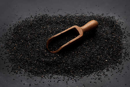 Black sesame seed on black background. Organic food concept.の写真素材
