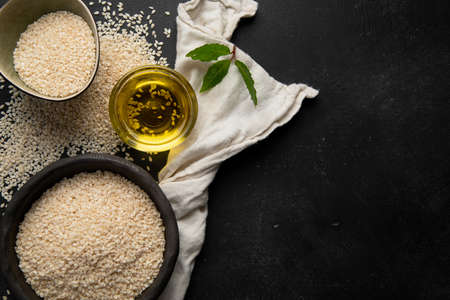Black and white sesame seed on black background. Organic food concept Top view, Copy spaceの写真素材