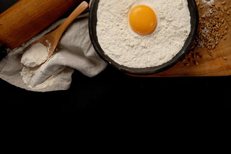 Wheat flour on dark background. Food preparing concept. Top view, copy spaceの写真素材