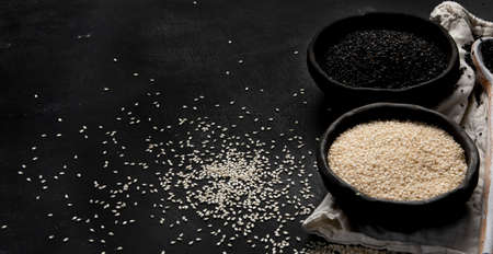 Black and white sesame seed on black background. Organic food concept. Copy spaceの写真素材