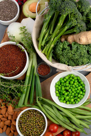 Assorted vegetables and cereal on gray background. Healthy food concept. Top view