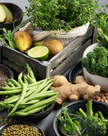 Assorted green vegetables and cereal on gray background. Healthy food concept.の写真素材